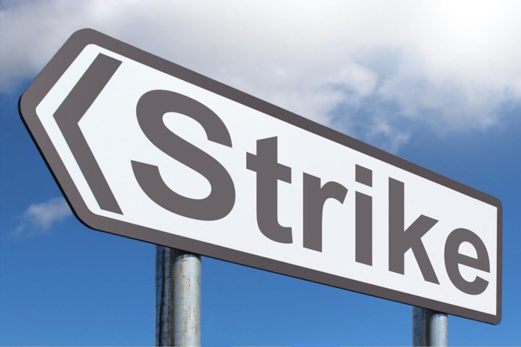 Signpost reads "Strike"